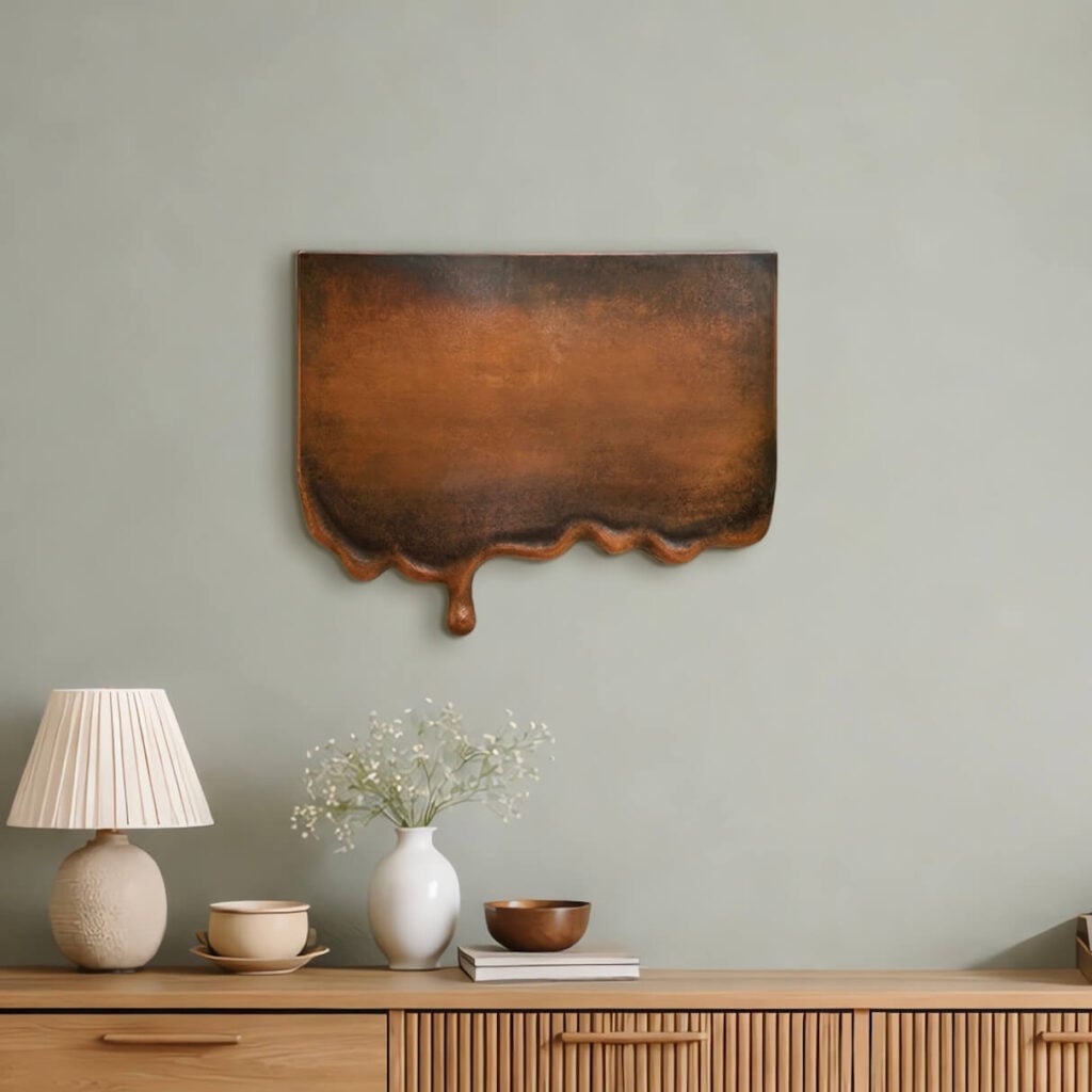 Metal Wall Art Melting copper wall sculpture on green wall