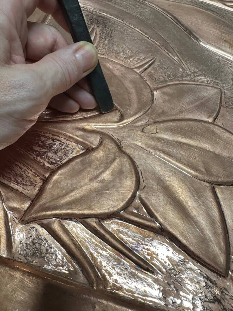 metal flower relief chasing close up